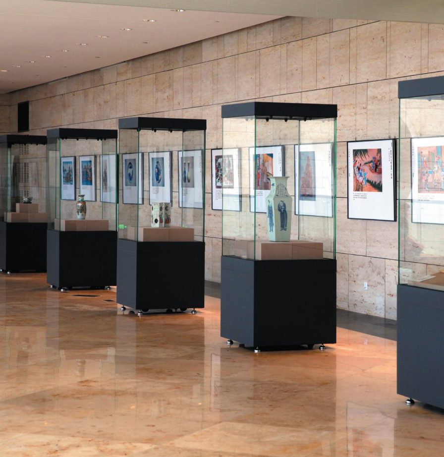 Row of climate-controlled museum display cases in a gallery