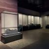 Museum climate-controlled display case with rare book on view